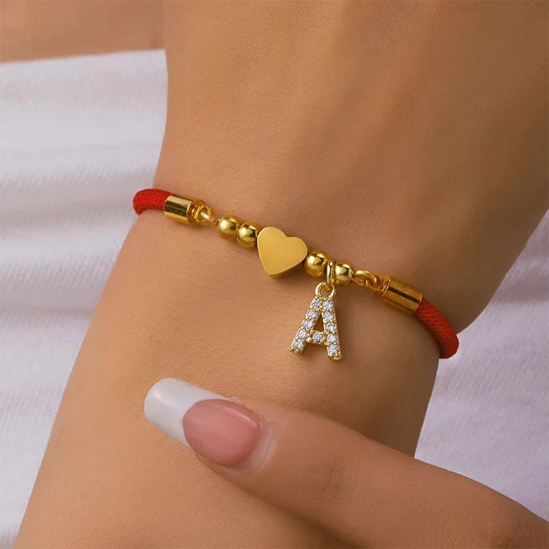 Rotes Armband mit Buchstabe und goldenem Herz
